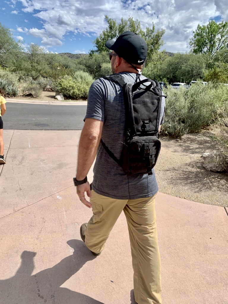 Husband wearing an unneeded water backpack